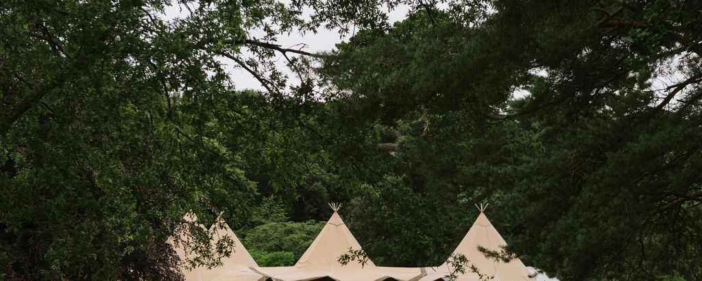 Four Tipis linked together with an open front ready to welcome wedding guests