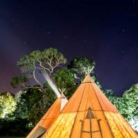 Two tipis are lit up under the stars at Mount Stewart's Festival of Light in Northern Ireland