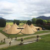 Six tipis are joined together in a doughnut formation in the grounds of a country estate