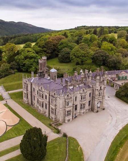 Amazing drone shot of Narrow water Castle with a six tipi doughnut set up in the estate gardens