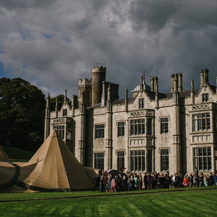 Guests arrive at a magnificent four tipi Wedding set up in front of Narrow Water Castle