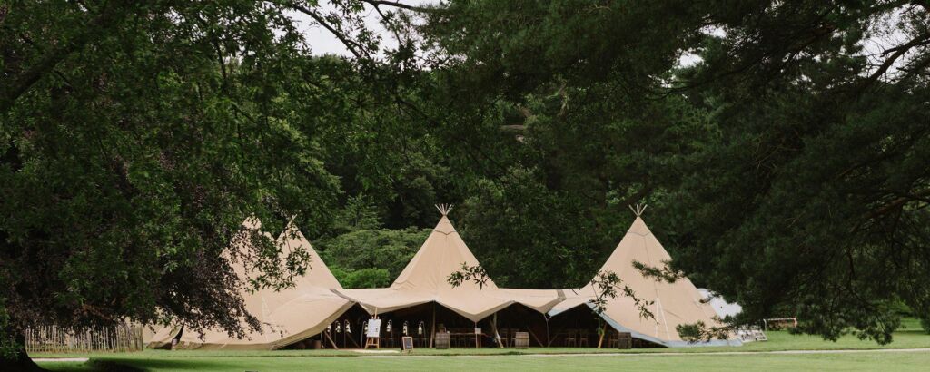 Mount stewart four tipi wedding setup on a green field