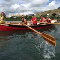 Rowers in a Skiff on Strangford Lough, Tipis and Delamont Country Park are in the background