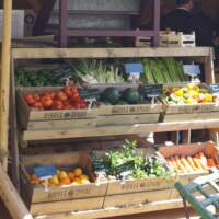 Vegetables sit in wooden crates on display inside a tipi at the Odaios Food Fair Festival
