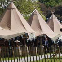 6 Tipi Festival set up with bunting decorating the tops of the Tipis at a Food Fair