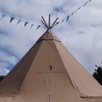A Festival Tipi is highlighted by bright blue skies and bunting at a Food Fair in Dublin