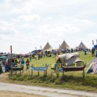 Skiffie Festival at Delamont Country Park  it is full of visitors, tents, gazebos and three Tipis are in the background
