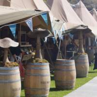 Six Tipi's line up at a food festival with colourful blue bunting decoration