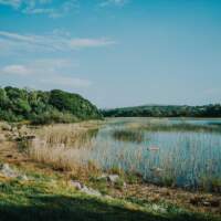 A stunning lake sits within the beautiful Irish countryside