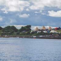 Strangford Lough sits on front with a jetty for launching skiffs, three tipis and Delamon Country Park are in the background