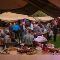 A buffet table sits in the foreground with Tipis and guests behind at the Rite Hite Custom Ireland Corporate Event