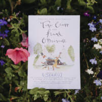 Wedding invitation featuring an illustration of two tipis and dancing foxes