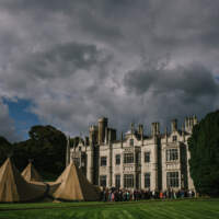 Guests arrive at a magnificent four tipi Wedding set up in front of Narrow Water Castle