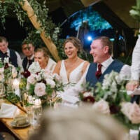 Couple and wedding party celebrate a spring wedding in a beautiful tipis