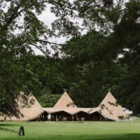 Four Tipis linked together with an open front ready to welcome wedding guests
