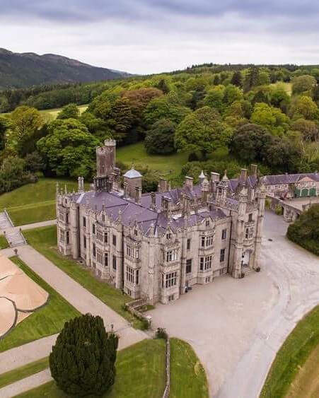 Amazing drone shot of Narrow water Castle with a six tipi doughnut set up in the estate gardens