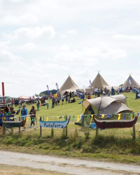 Skiffie Festival at Delamont Country Park  it is full of visitors, tents, gazebos and three Tipis are in the background