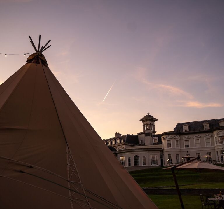 A Tipi sits in front of the K club, County Kildare at sunset