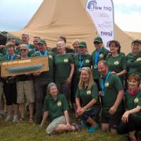 Dundrum Coastal Rowing club celebrate their win in front of Magnakata Tipis at Delamont Country Park