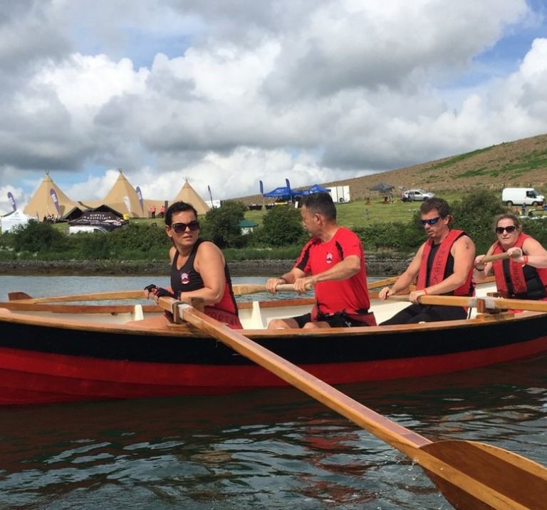 Rowers in a Skiff on Strangford Lough, Tipis and Delamont Country Park are in the background