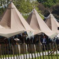 6 Tipi Festival set up with bunting decorating the tops of the Tipis at a Food Fair