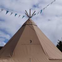 A Festival Tipi is highlighted by bright blue skies and bunting at a Food Fair in Dublin