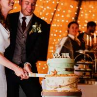 The bride and groom cut a nautical themed wedding cake