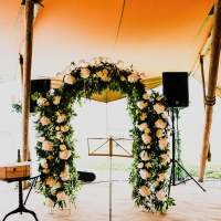 A beautiful floral arch sits at the ceremony inside the tipi ready for bride and groom to arrive