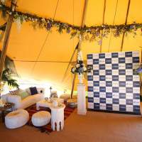 Arabian furniture and a Dubai Duty Free Corporate photobooth decorate the inside of the Tipis