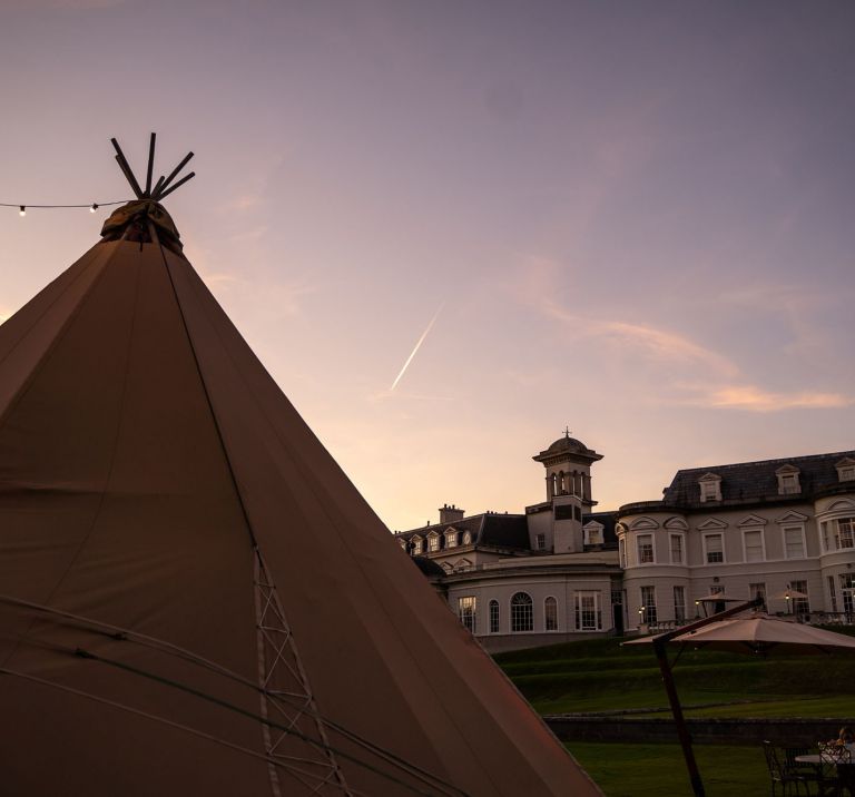 A Tipi sits in front of the K club, County Kildare at sunset