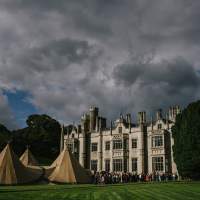 Guests arrive at a magnificent four tipi Wedding set up in front of Narrow Water Castle