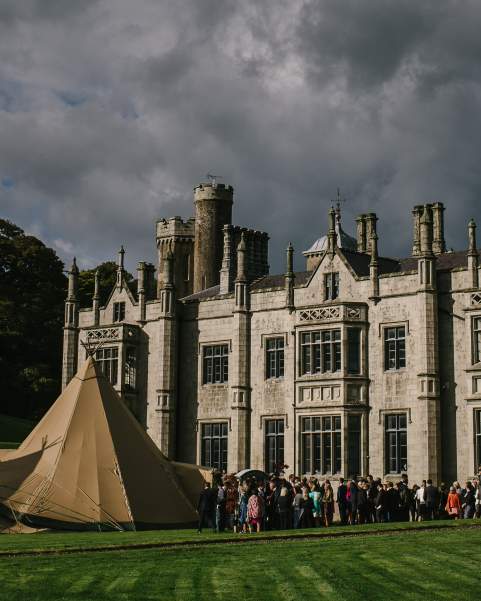 Guests arrive at a magnificent four tipi Wedding set up in front of Narrow Water Castle