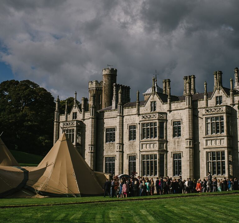 Guests arrive at a magnificent four tipi Wedding set up in front of Narrow Water Castle